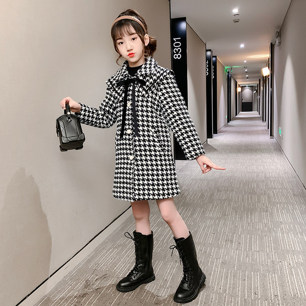 Must-valge ja taskutega lastemantel