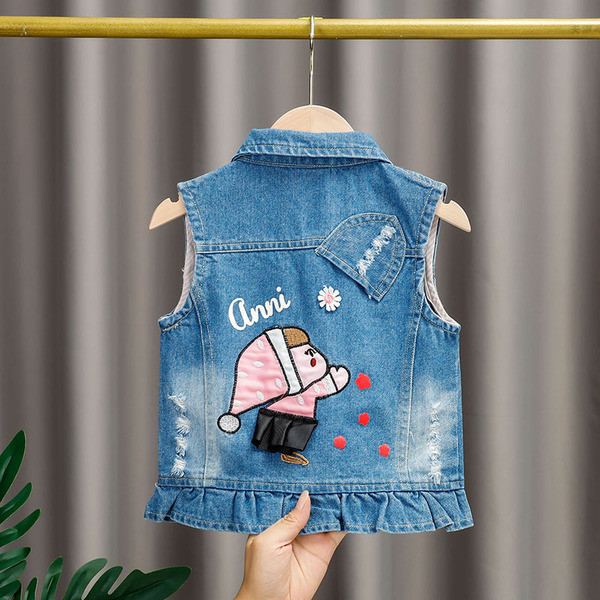 Moodne laste teksavest tüdrukutele, mille seljal on aplikatsioon