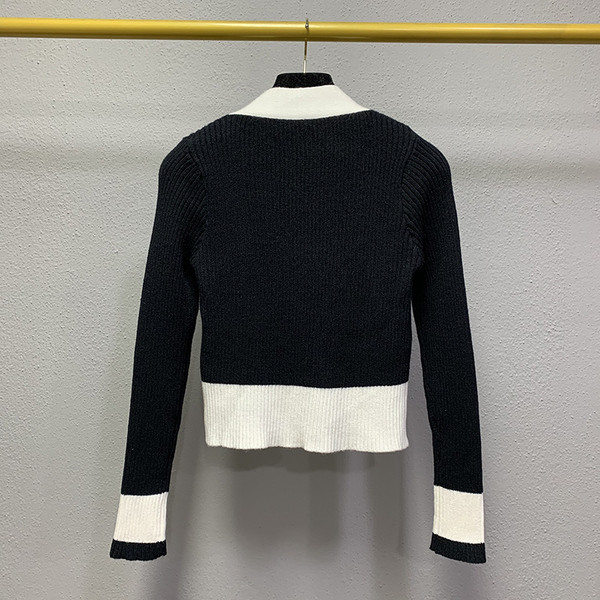 Naiste kaasaegne must-valge spitsikaelusega vest