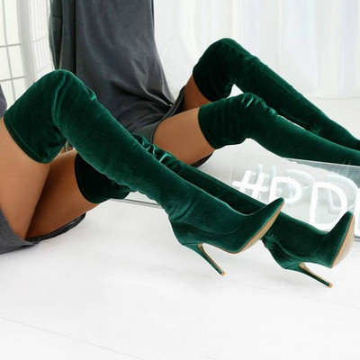 Women`s boots above the knee made of plush and high heels