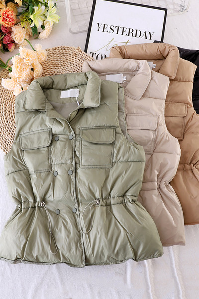 Naiste vest taskute ja elastse vöökohaga