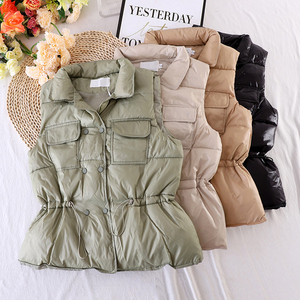 Naiste vest taskute ja elastse vöökohaga