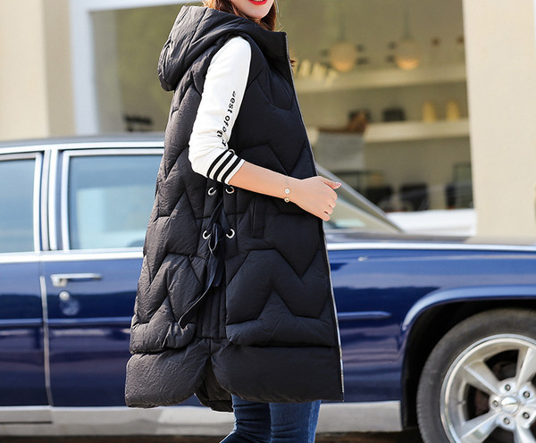 Pikk naiste sügis-talvine vest kapuutsi ja taskutega