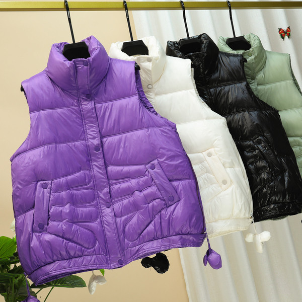 Laia mudeliga naiste vest kõrge krae ja taskutega