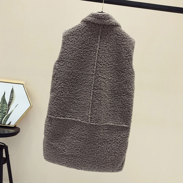 Naiste pikk taskute ja ududega vest