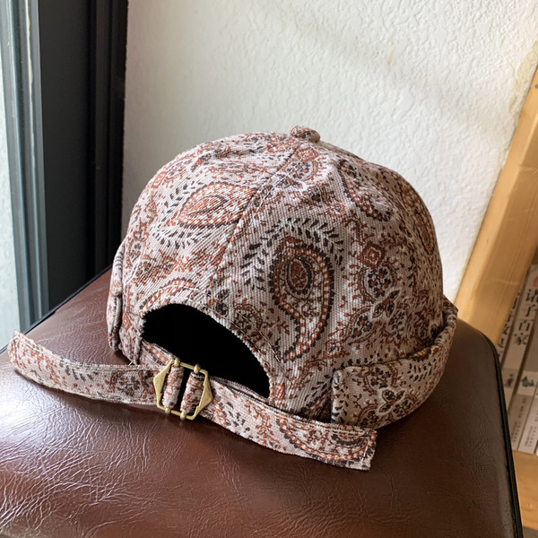 Alkalmi női sapka napellenzővel és virágmotívumokkal