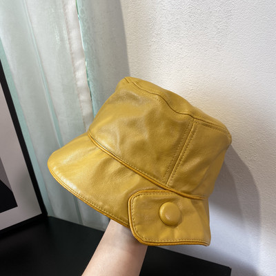 Aktuális női sapka műbőrből, gombbal