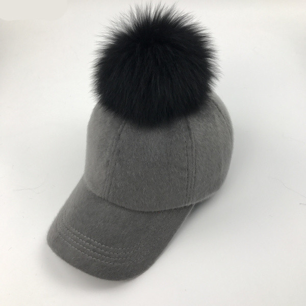 Modern női téli sapka tollal és napellenzővel