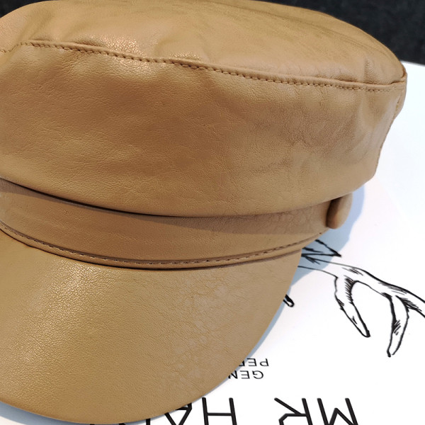 Női bőr sapka gombbal