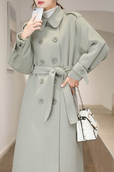 Hosszú női kabát gallérral és kétsoros rögzítéssel