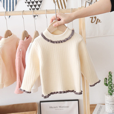 Alkalmi gyerekpulóver magas gallérral és fürtökkel, lányok számára