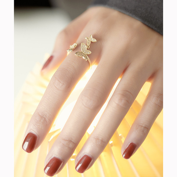 Hétköznapi női gyűrű pillangókkal és díszkövekkel