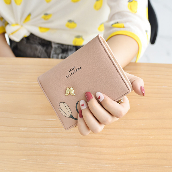 Naiste nahast rahakott metallist liblika ja trükiga