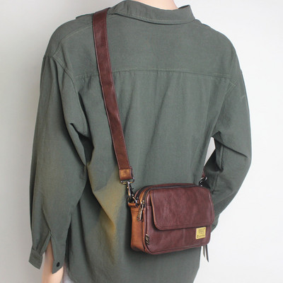 Kandilise kujuga tekstiilist sangaga meestekott