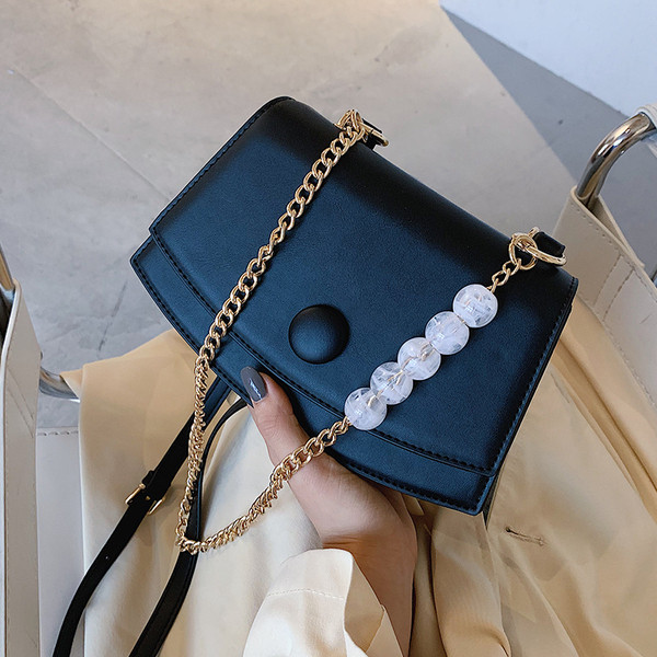 Modern bőrtáska fém fogantyúval és gyöngyökkel