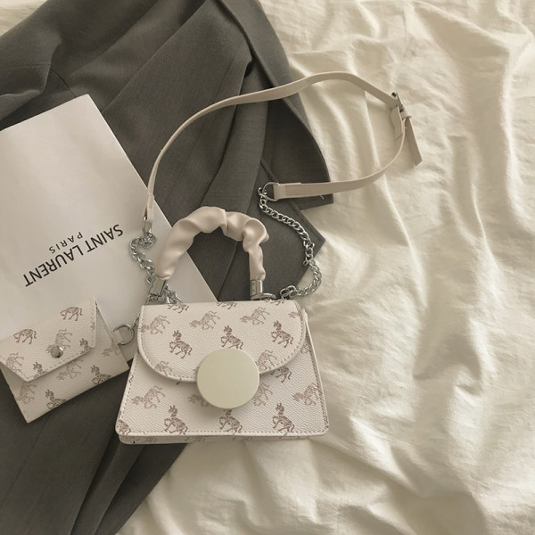 Kis négyzet alakú táska két fogantyúval és nyomattal