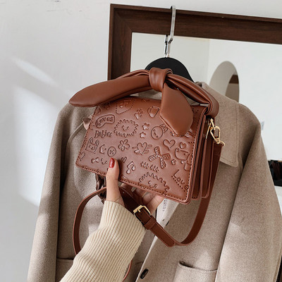 Elegantna torbica s vrpcom i dugom ručkom