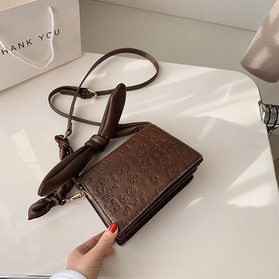 Elegantna torbica s vrpcom i dugom ručkom