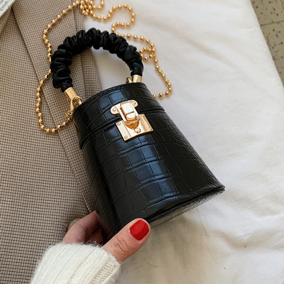 Kis női bőrtáska fém csattal és lánccal