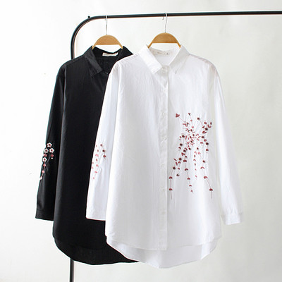 Women`s shirt asymmetrical model with a classic collar in white and black