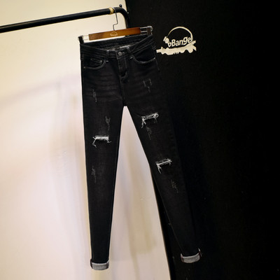 Naiste elastsed kõrge vöökoha ja rebenenud motiividega teksad