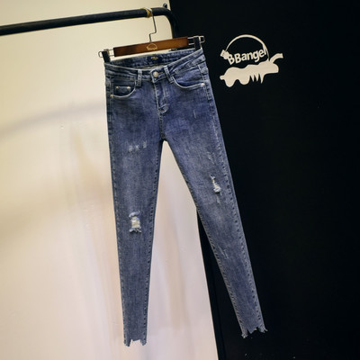 Sinise ja halli värvi rebenenud motiividega elastsed naiste teksad