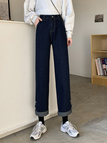 Naiste laiad nööpide ja kõrge vöökohaga teksad