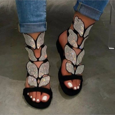 Modern women`s sandals with flat soles and stones