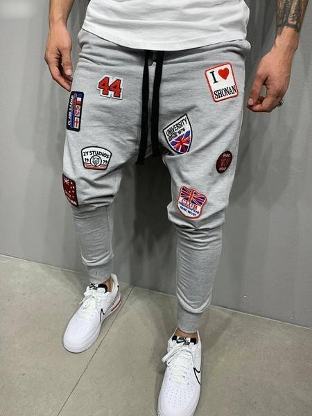 Vīriešu sportiski elegantas bikses ar aplikācijām un saitēm