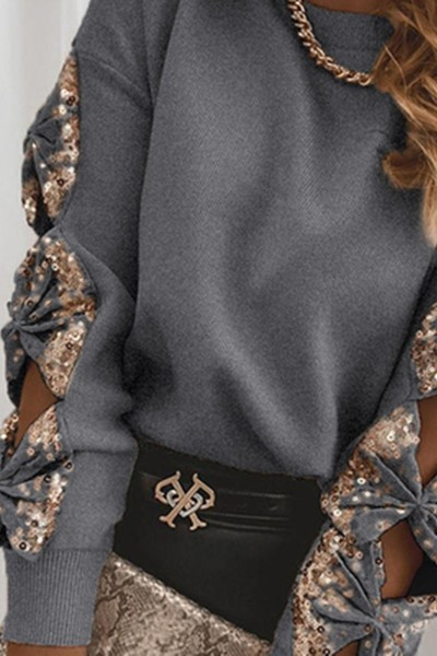 Moderna ženska bluza s rupama na rukavima i šljokicama