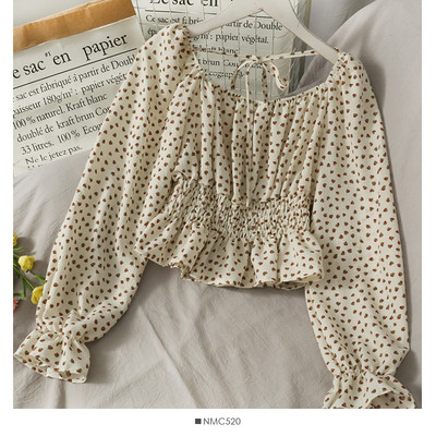 Ženska bluza na točkice s dugim rukavima i vezicama