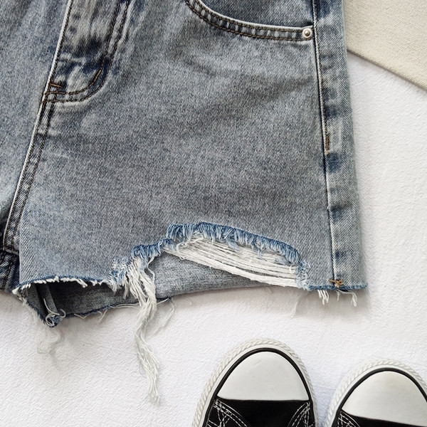 Jauns īsu sieviešu džinsu modelis ar aplikāciju un saplēstu motīvu