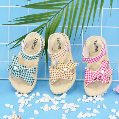 Modern children`s plaid sandals with ribbon for girls
