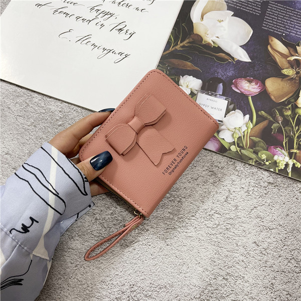 Γυναικείο πορτοφόλι από οικολογικό δέρμα με λαβή και κορδέλα