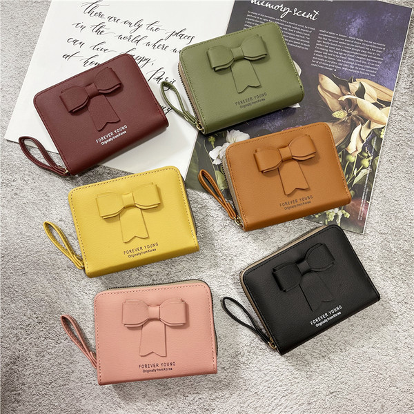 Γυναικείο πορτοφόλι από οικολογικό δέρμα με λαβή και κορδέλα