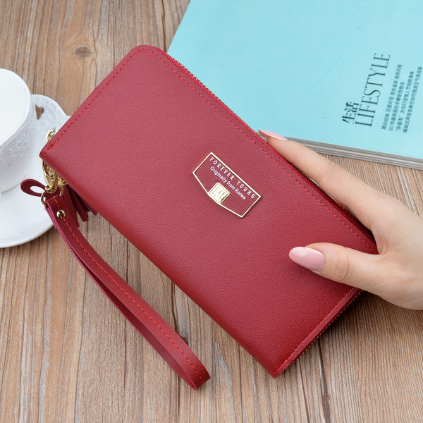 Γυναικείο μοντέρνο πορτοφόλι με κοντή λαβή και φούντα