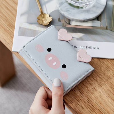 Μικρό γυναικείο πορτοφόλι με τρισδιάστατο στοιχείο και μεταλλική στερέωση