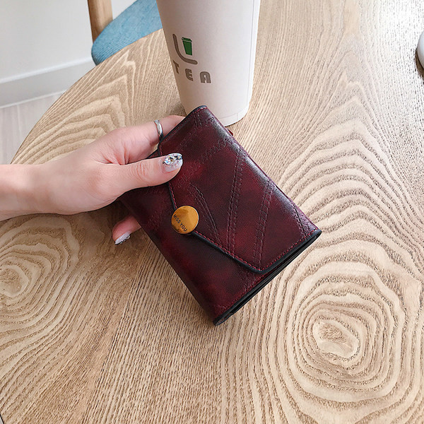 Γυναικείο μικρό πορτοφόλι με μεταλλική στερέωση και επιγραφή