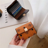 Γυναικείο μίνι πορτοφόλι με μεταλλική στερέωση και εφαρμογές