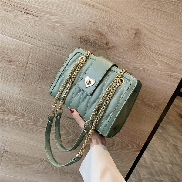 Geantă modernă de damă din piele, cu mâner metalic lung