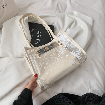 Γυναικεία διαφανής τσάντα με μεταλλικά στοιχεία