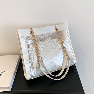 Moderna liela soma ar caurspīdīgu daļu un uzrakstiem