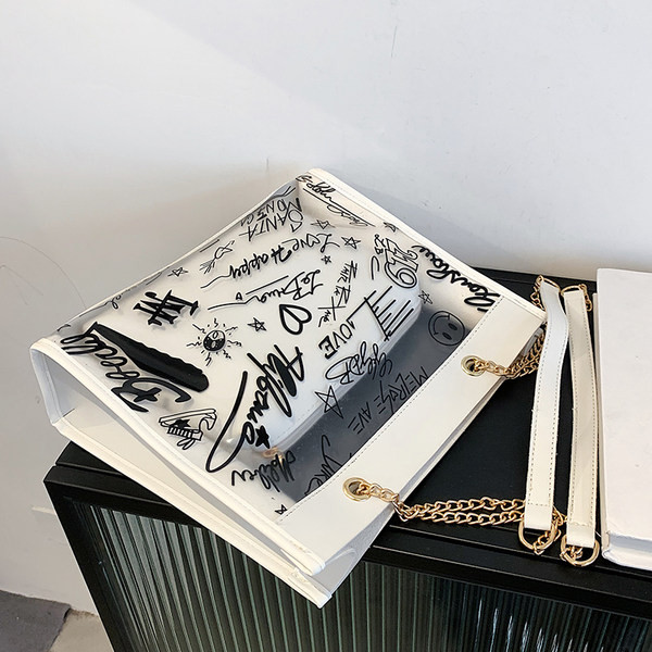 Moderna liela soma ar caurspīdīgu daļu un uzrakstiem