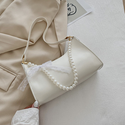 Γυναικεία έκο δερμάτινη τσάντα με κοντή λαβή από πέρλες και κορδέλα