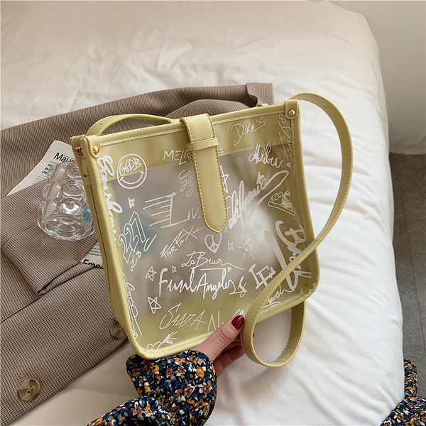 Γυναικεία διαφανής τσάντα με επιγραφή και μακριά λαβή