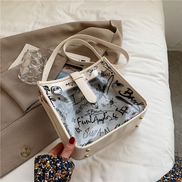 Γυναικεία διαφανής τσάντα με επιγραφή και μακριά λαβή