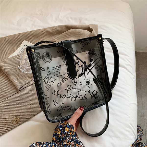 Γυναικεία διαφανής τσάντα με επιγραφή και μακριά λαβή