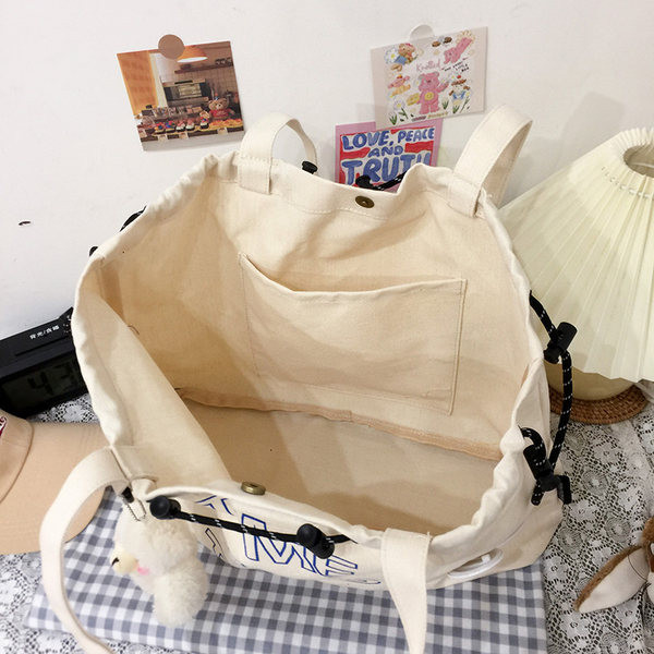 Ikdienas sieviešu soma ar uzrakstiem un aksesuāru