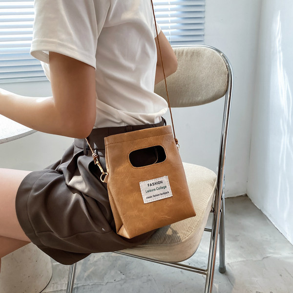 Γυναικεία δερμάτινη τσάντα με έμβλημα και μακριά λαβή