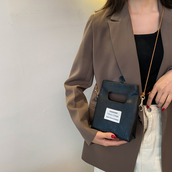 Γυναικεία δερμάτινη τσάντα με έμβλημα και μακριά λαβή